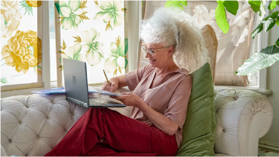 A therapist taking notes during a teletherapy appointment